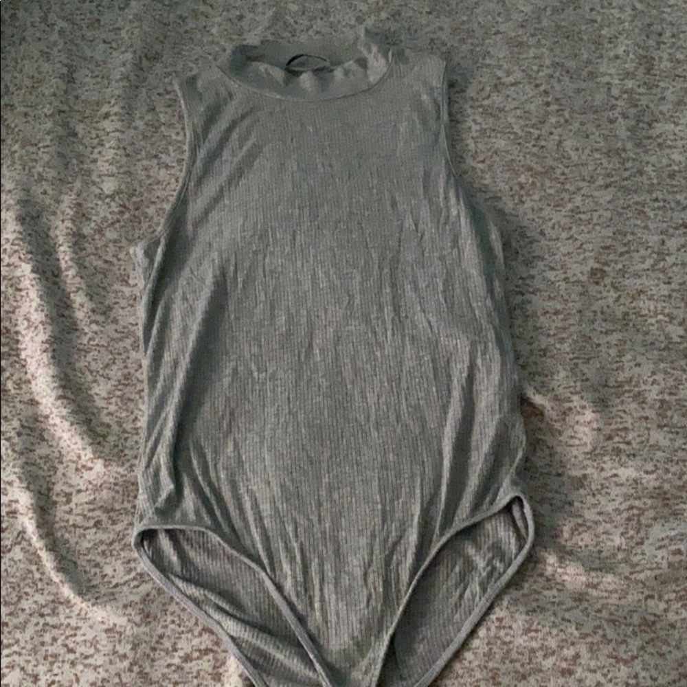 a grey turtle neck bodysuit